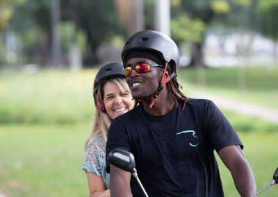 Tandem cyclists ride along a bicycle path in traffic clogged Sao Paulo Brazil